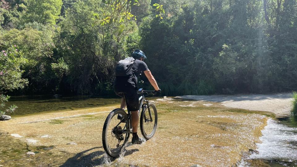 crossing the stream that feeds the Istán Lake