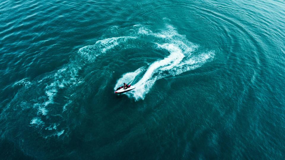 a man in a jetboat at the ocean