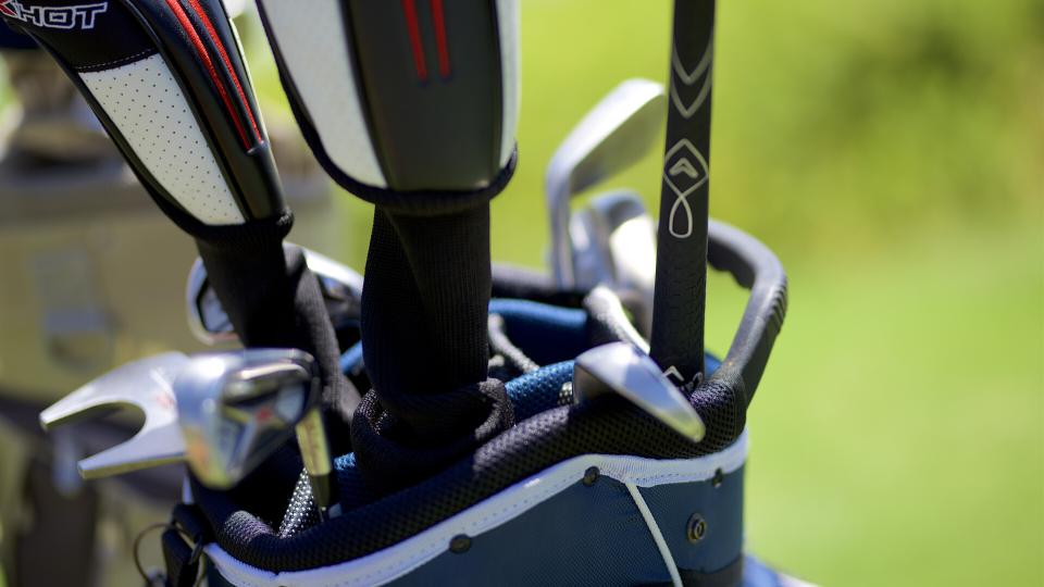 someone carrying golf equipment